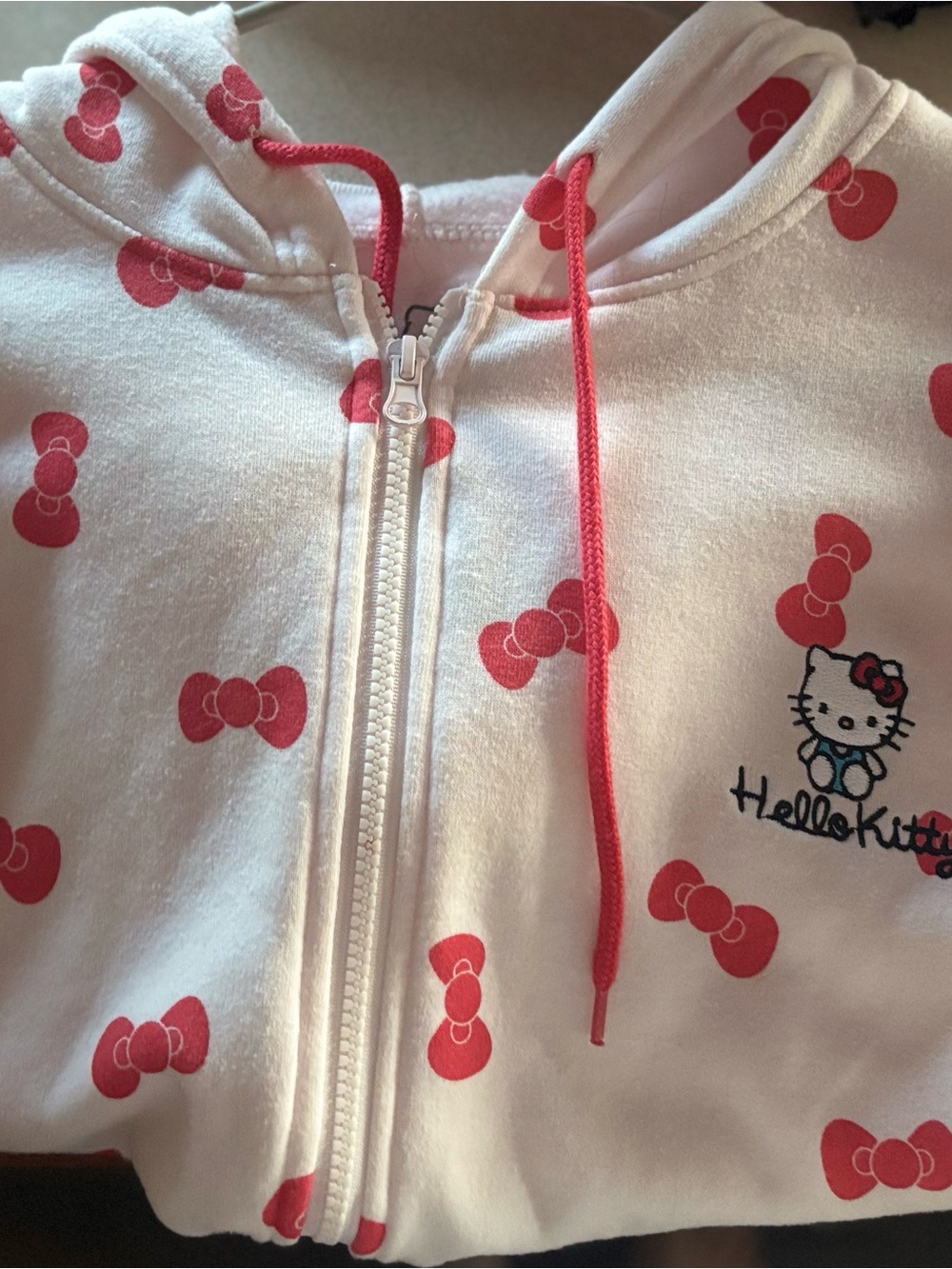 Sanrio Hello Kitty Light Pink Zip Hoodie with Red Bow Print